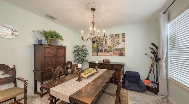 dining space with a wealth of natural light and a chandelier