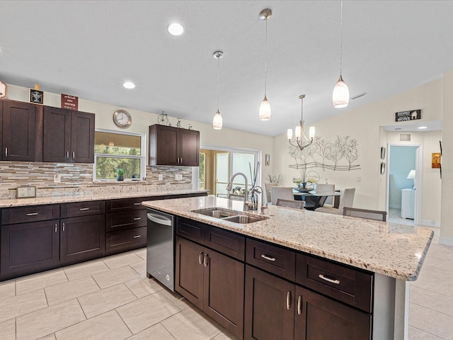 kitchen with dishwasher, sink, backsplash, an island with sink, and decorative light fixtures