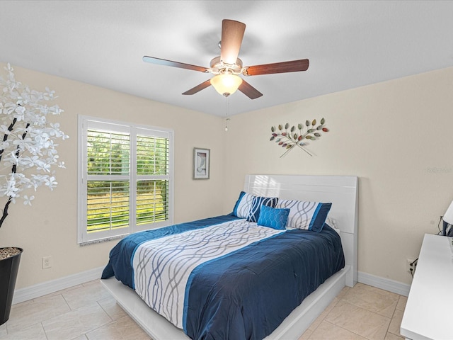 tiled bedroom with ceiling fan