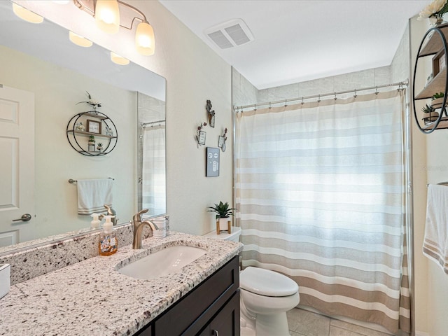 bathroom featuring tile patterned floors, vanity, and toilet