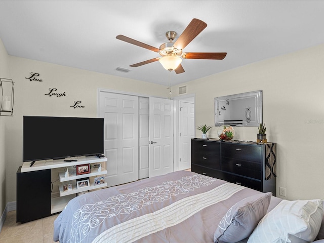 bedroom featuring a closet, ceiling fan, and light tile patterned flooring