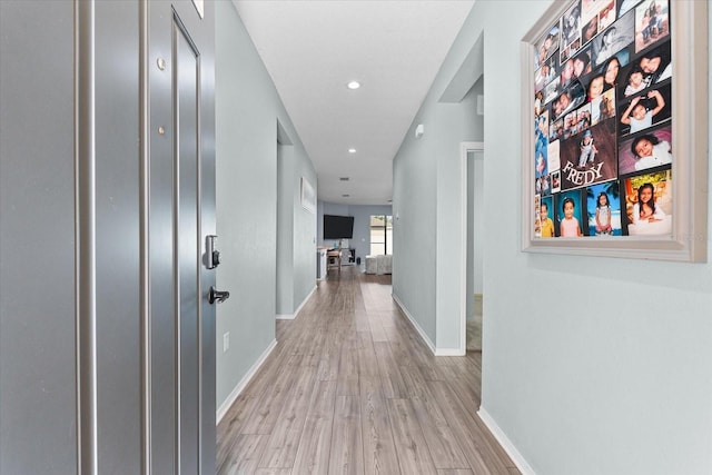 corridor with light hardwood / wood-style flooring