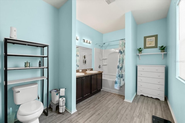 full bathroom featuring vanity, toilet, hardwood / wood-style floors, and shower / bath combo