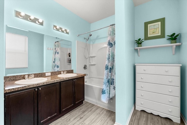 bathroom with vanity, hardwood / wood-style floors, and shower / bath combo with shower curtain