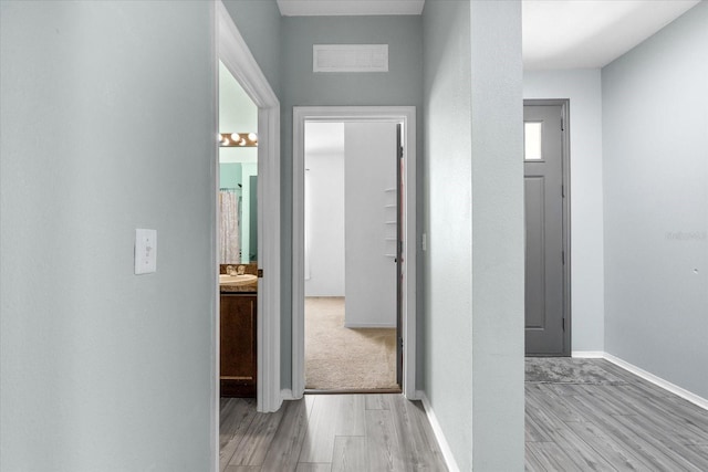 corridor featuring light hardwood / wood-style floors