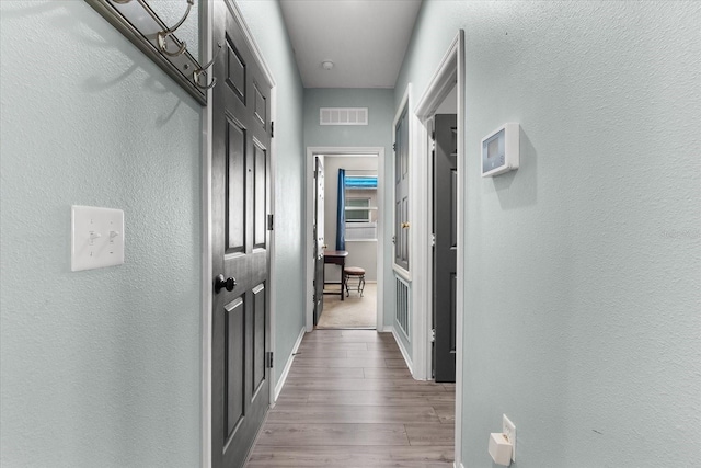 hallway featuring hardwood / wood-style flooring