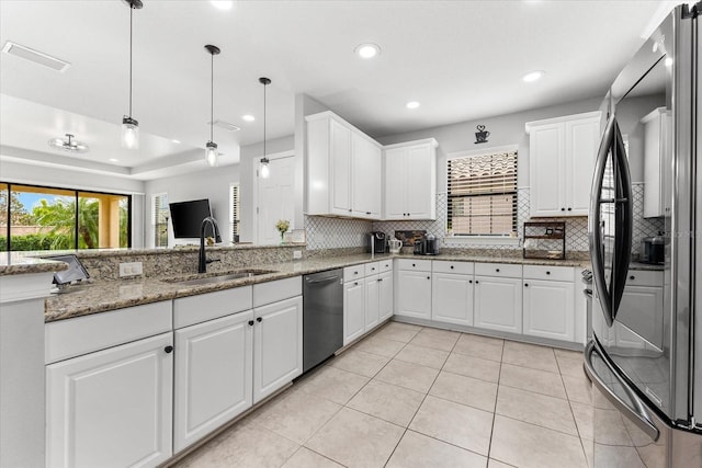 kitchen featuring white cabinets, appliances with stainless steel finishes, and sink