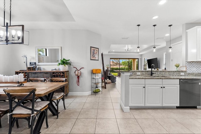 kitchen with white cabinets, dishwasher, a tray ceiling, and pendant lighting