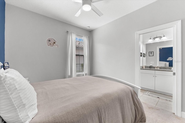 bedroom featuring ceiling fan, sink, connected bathroom, and light tile patterned floors