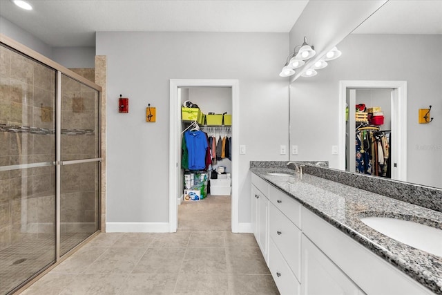 bathroom with tile patterned floors, an enclosed shower, and vanity