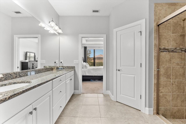 bathroom with tile patterned floors, vanity, and an enclosed shower