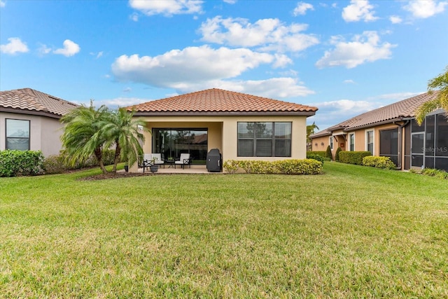 rear view of property with a lawn and a patio