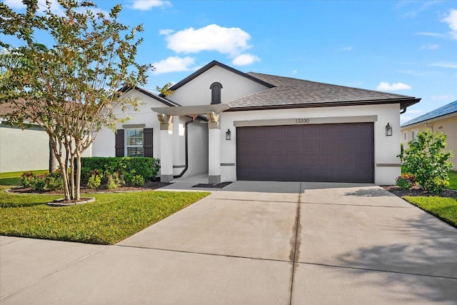 view of front of property with a front yard and a garage