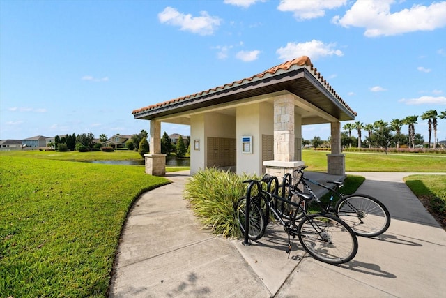 surrounding community featuring a yard and a water view