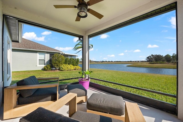 sunroom / solarium with a wealth of natural light, ceiling fan, and a water view