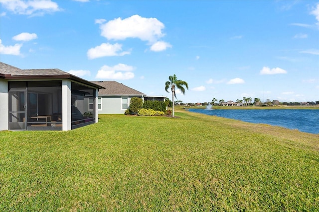 view of yard featuring a water view and a sunroom