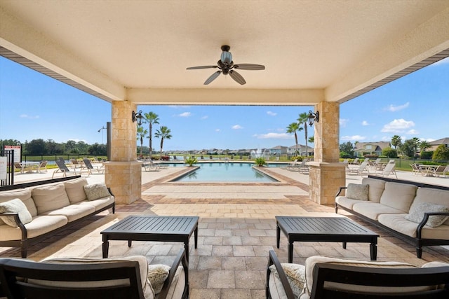 view of patio featuring a water view, ceiling fan, a community pool, and outdoor lounge area