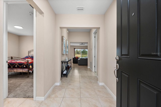 hallway with light tile patterned floors