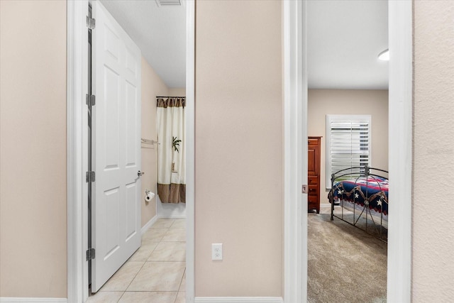 corridor with light colored carpet