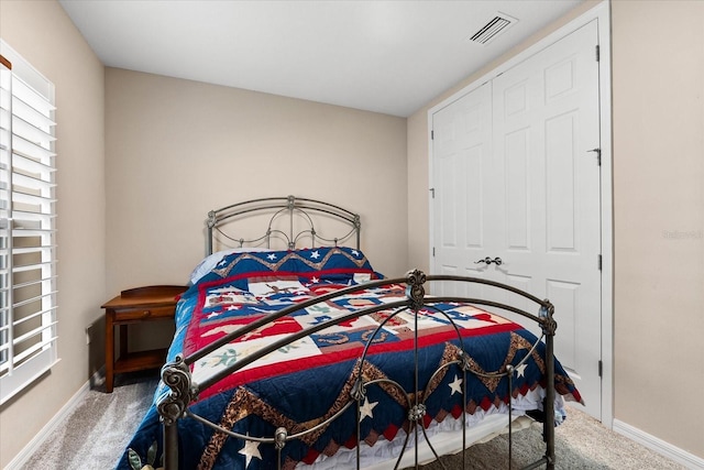 bedroom with carpet and a closet