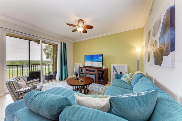 tiled living room with ceiling fan and crown molding