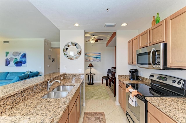 kitchen featuring light stone countertops, ornamental molding, stainless steel appliances, sink, and light tile patterned floors