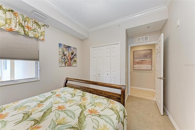 carpeted bedroom featuring a closet and ornamental molding