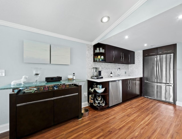 kitchen with tasteful backsplash, dark brown cabinetry, stainless steel appliances, light hardwood / wood-style flooring, and lofted ceiling