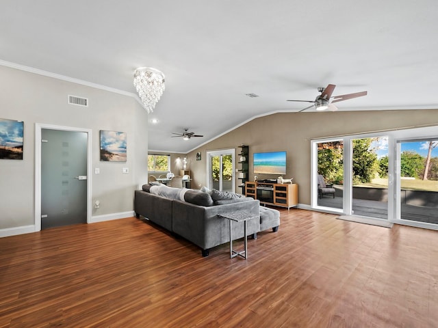 living room with wood-type flooring, ceiling fan with notable chandelier, and a wealth of natural light