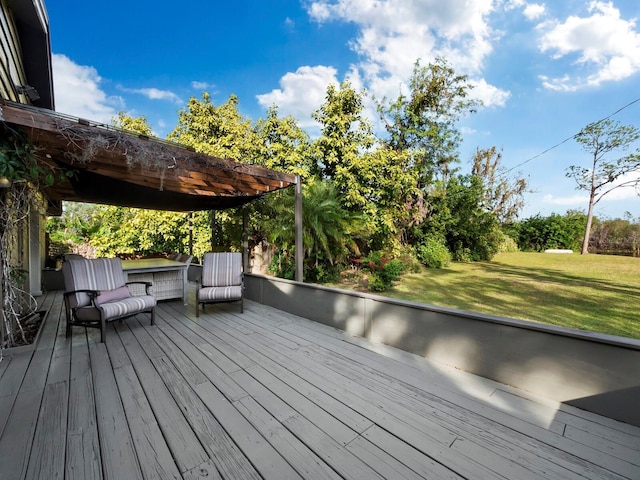 wooden terrace featuring a lawn