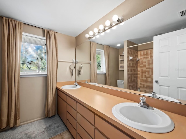 bathroom with vanity, tile patterned flooring, curtained shower, and toilet