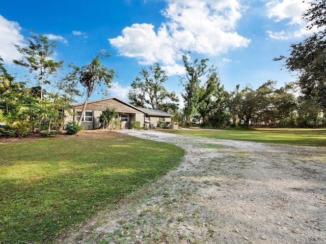 5645 Churchill Downs Rd, Sarasota, FL 34241 - view of front of home with gravel driveway and a front lawn