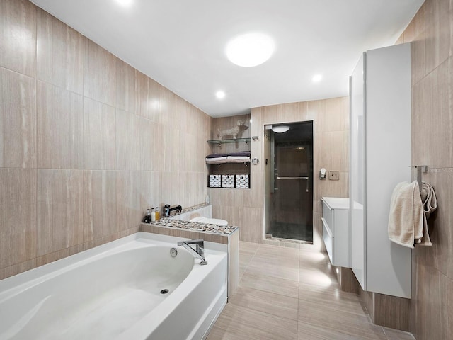 5645 Churchill Downs Rd, Sarasota, FL 34241 - full bath with tile walls, a bath, a shower stall, tile patterned floors, and vanity