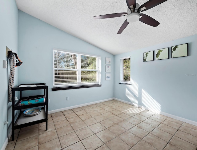 5645 Churchill Downs Rd, Sarasota, FL 34241 - tiled empty room with a textured ceiling, vaulted ceiling, and a ceiling fan