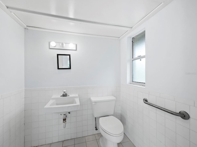 5645 Churchill Downs Rd, Sarasota, FL 34241 - bathroom featuring toilet, tile walls, a wainscoted wall, and tile patterned flooring