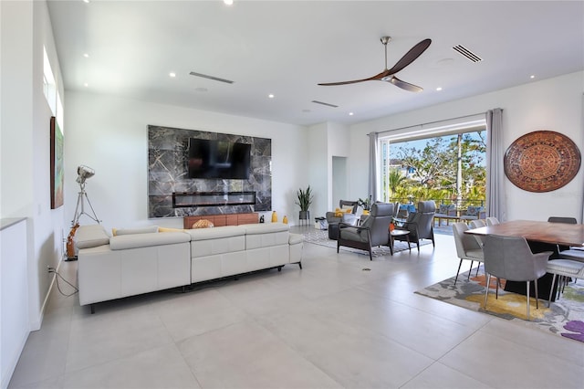 living area featuring recessed lighting, visible vents, ceiling fan, and a fireplace