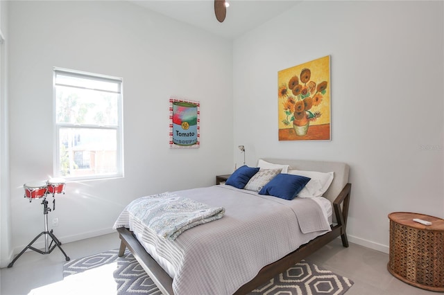 bedroom with ceiling fan and baseboards