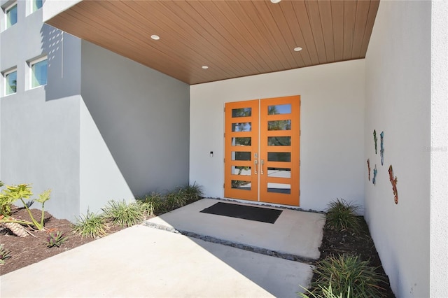 view of exterior entry with french doors and stucco siding