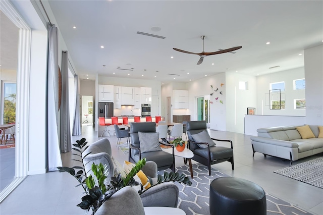 living area with ceiling fan, visible vents, and recessed lighting