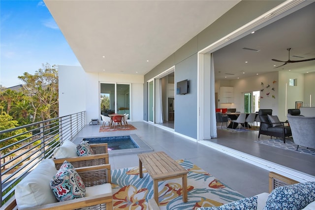 balcony featuring visible vents, ceiling fan, and an outdoor living space