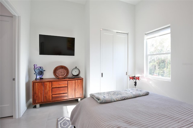 bedroom featuring a closet and light tile patterned floors