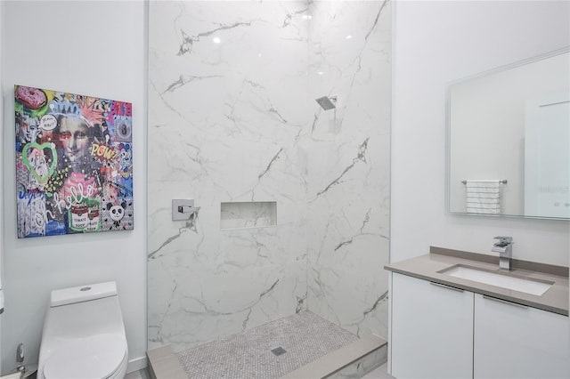 bathroom with a marble finish shower, vanity, and toilet