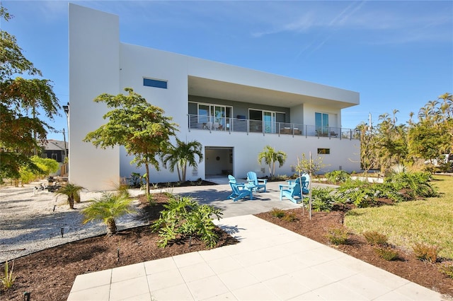 view of front of home featuring a patio area and stucco siding