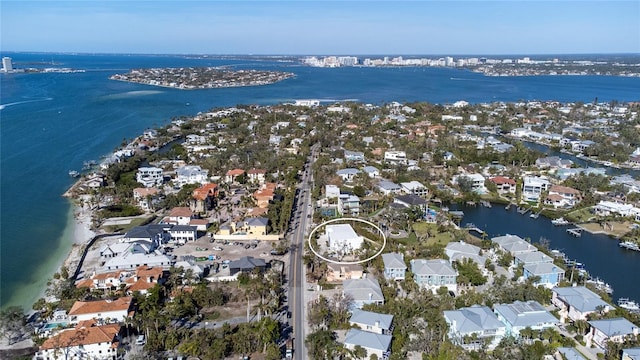 drone / aerial view featuring a water view and a residential view