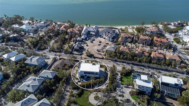 drone / aerial view featuring a residential view and a water view