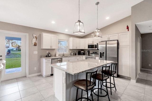 kitchen with stainless steel appliances, a center island, sink, and white cabinets