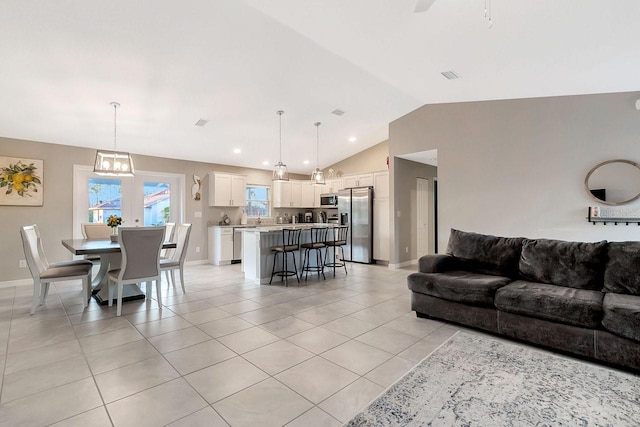 living room with lofted ceiling and light tile patterned floors