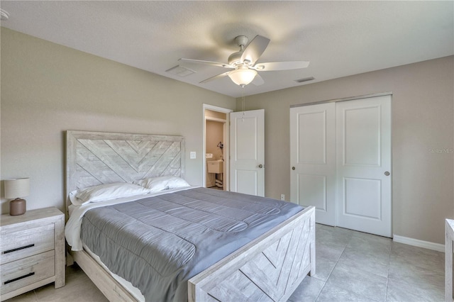 tiled bedroom with a closet and ceiling fan