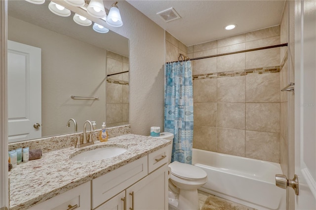 full bathroom featuring tile patterned floors, toilet, shower / tub combo, a textured ceiling, and vanity