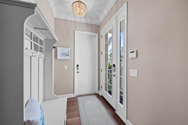 interior space with a chandelier, dark hardwood / wood-style flooring, and crown molding